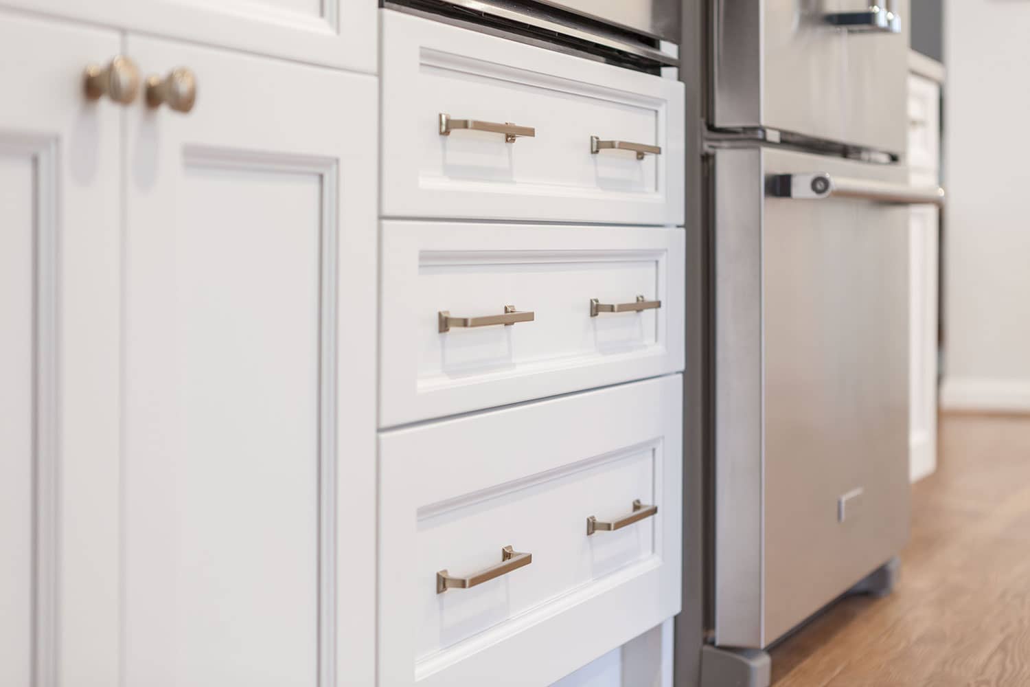 White kitchen cabinet drawer with gold handle